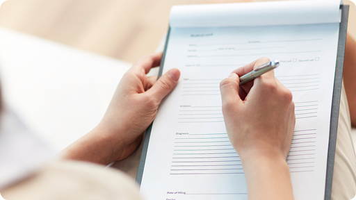 Person filling out a form on a clipboard
